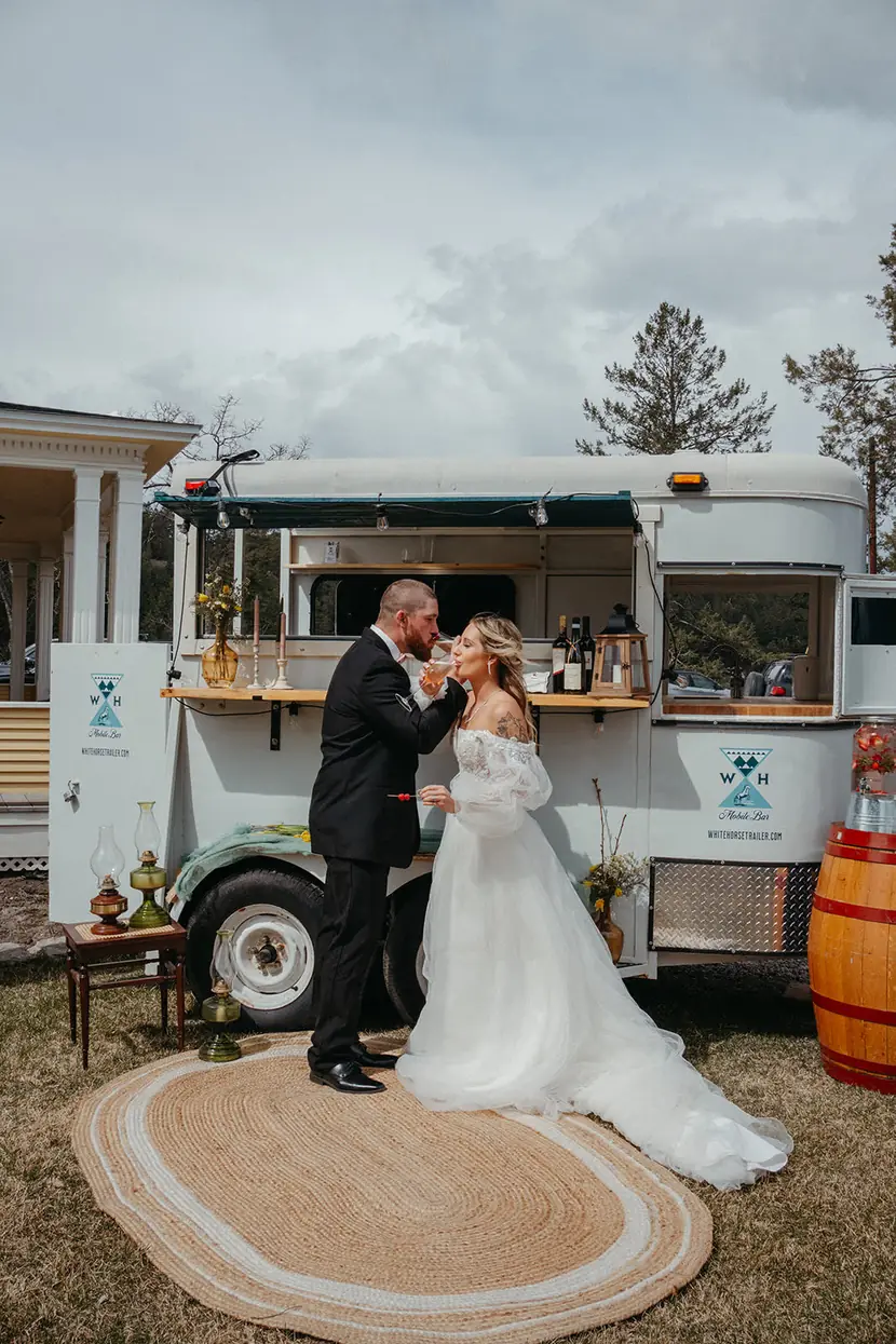 Couple sharing a first dance beside the mobile bar at their Montana wedding