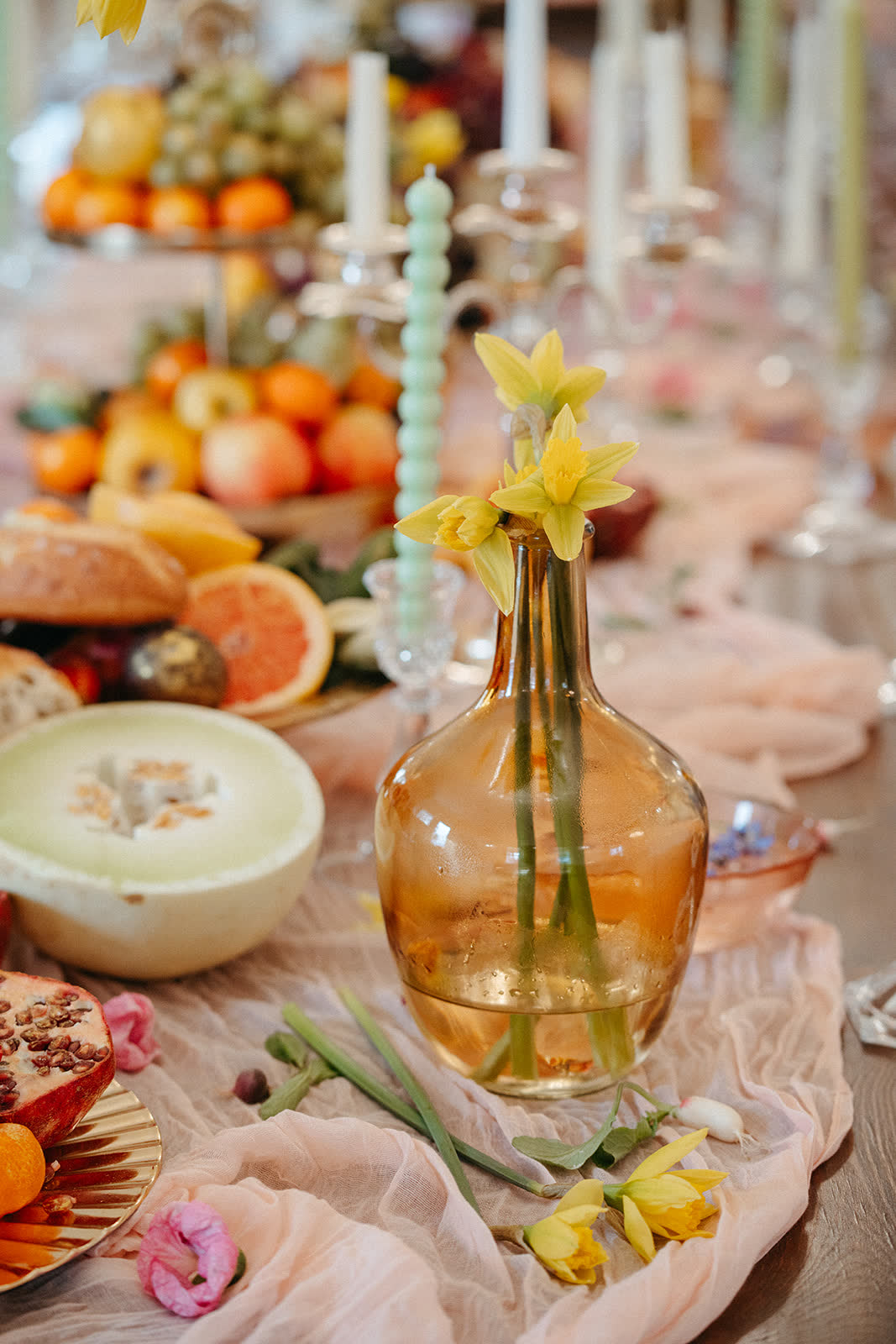Styled tablescape with citrus, candles, and glassware
